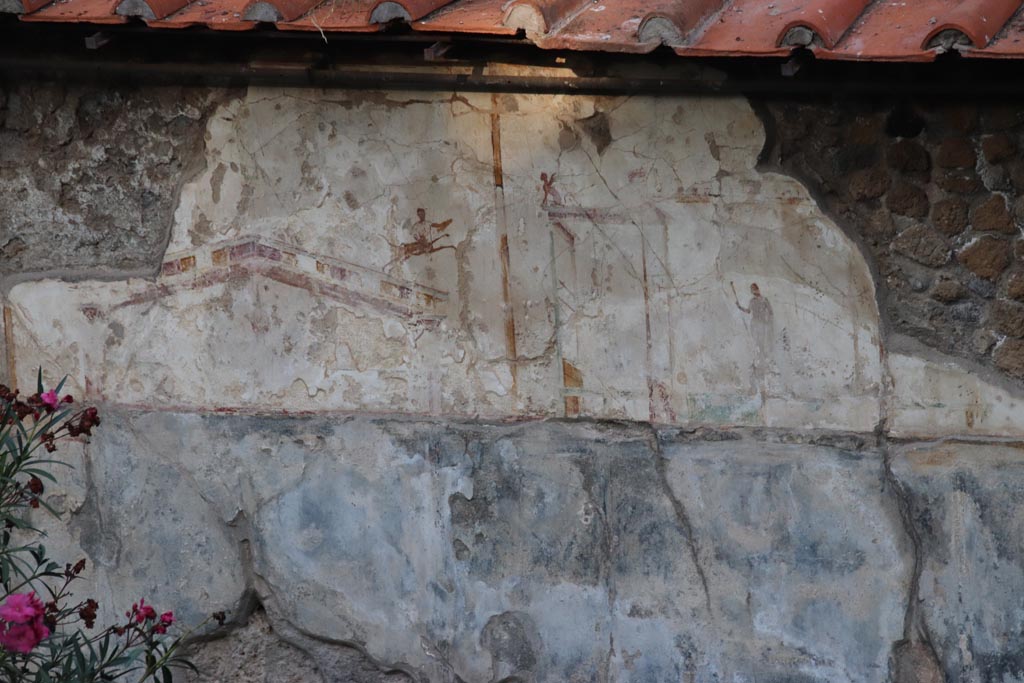VIII.1.a Pompeii. October 2023. Detail of painted plaster on east wall at side of the portico. Photo courtesy of Klaus Heese.