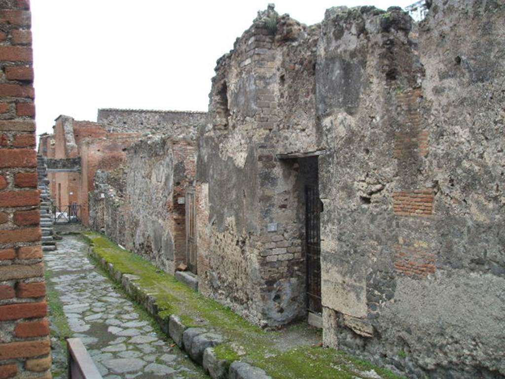 VIII.2.3 left and VIII.2.2 right, Pompeii. December 2004. Looking east along Vicolo di Championnet.