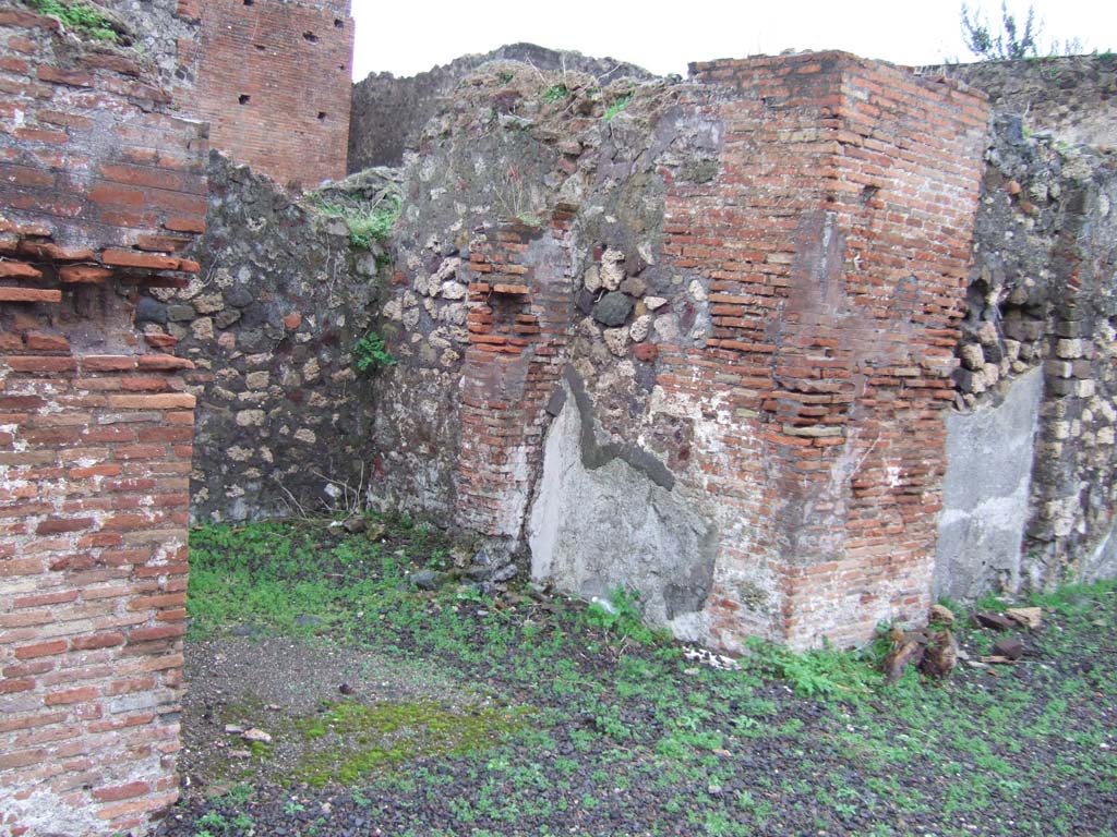 VIII.2.3 Pompeii. December 2005. Ala on east side of atrium.
According to PPM, the mosaic floor in this room would have been with a black background inset with white rows of tiles surrounded by a white border. The threshold of the room, no longer conserved, was drawn by Zahn and showed a rich decoration with flower/leaves elements.
