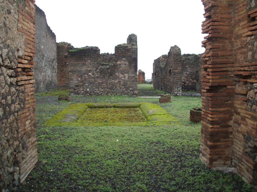 VIII.2.14 Pompeii. December 2004. Looking across atrium towards rooms at rear, from entrance corridor.
According to Jashemski, at the rear was a large peristyle garden, linked to VIII.2.16 by a room, opening on both ends to a different peristyle.
This garden was laid out on a volcanic ledge and was enclosed on four sides by a portico supported by fourteen columns.
There was a rectangular pool in the south-east corner of the peristyle, which had amphorae in it.
These would have served as a shady retreat for fish.
See Jashemski, W. F., 1993. The Gardens of Pompeii, Volume II: Appendices. New York: Caratzas. (p.205)
