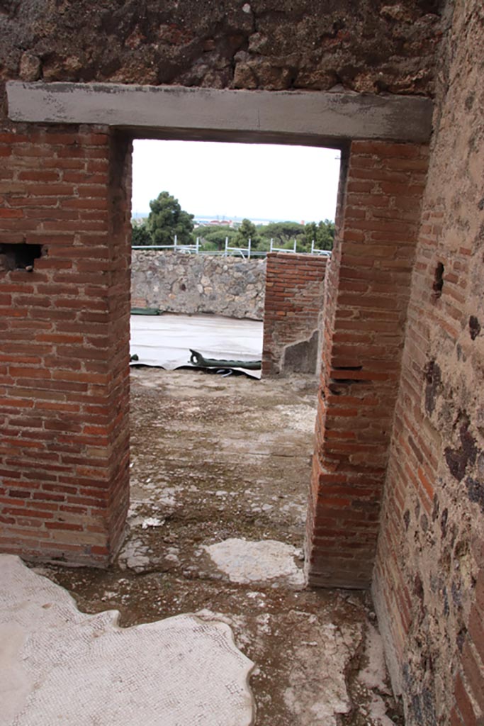 VIII.2.16 Pompeii. May 2024. Looking west in corridor.
Doorway from corridor in south-west corner of atrium, leading to room/cubiculum opening onto east portico. 
Photo courtesy of Klaus Heese.
