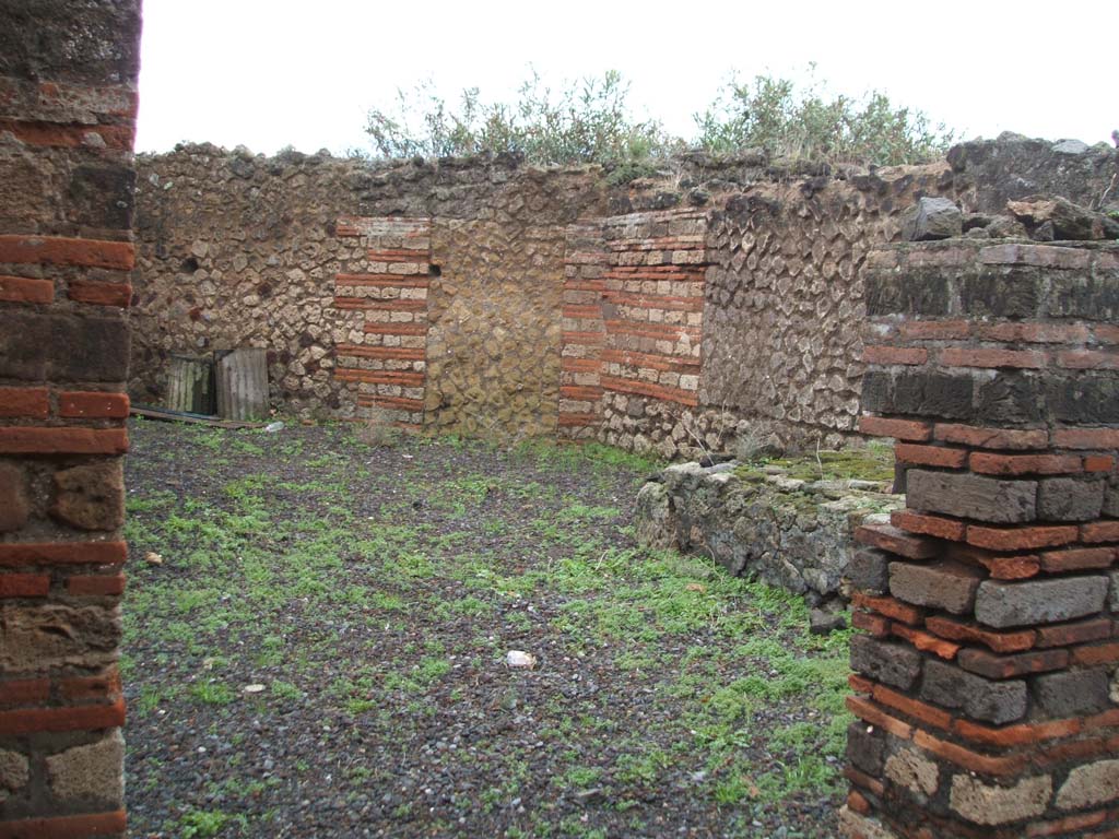 VIII.2.20 Pompeii. December 2004. Doorway to kitchen, with hearth or bench in corner.