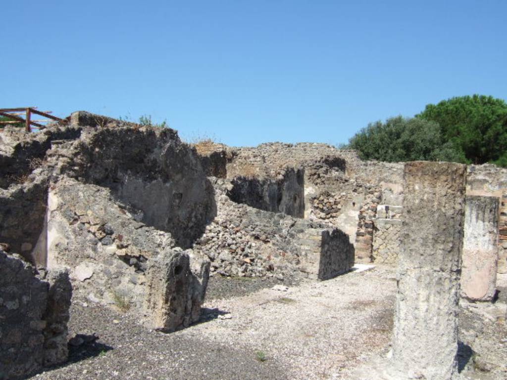 VIII.2.28 Pompeii. September 2005. Rooms on west side of atrium. According to Richardson, the rooms on the west side of the atrium were much shallower than those on the east.
The small rooms on either side of the central ala may have been storerooms.
See Richardson, L., 1988. Pompeii: an Architectural History. Baltimore: John Hopkins University Press. (p.231-2).

In the north-west corner of the atrium is a masonry base, just visible to the left of the column. This was the lararium. The top of it had three small steps of marble (see below). 
The aedicula that was originally on the base has disappeared. On the north wall above the base, when excavated, the figures of the Lares could still be seen.
See Boyce G. K., 1937. Corpus of the Lararia of Pompeii. Rome: MAAR 14. (p74, no.345)
