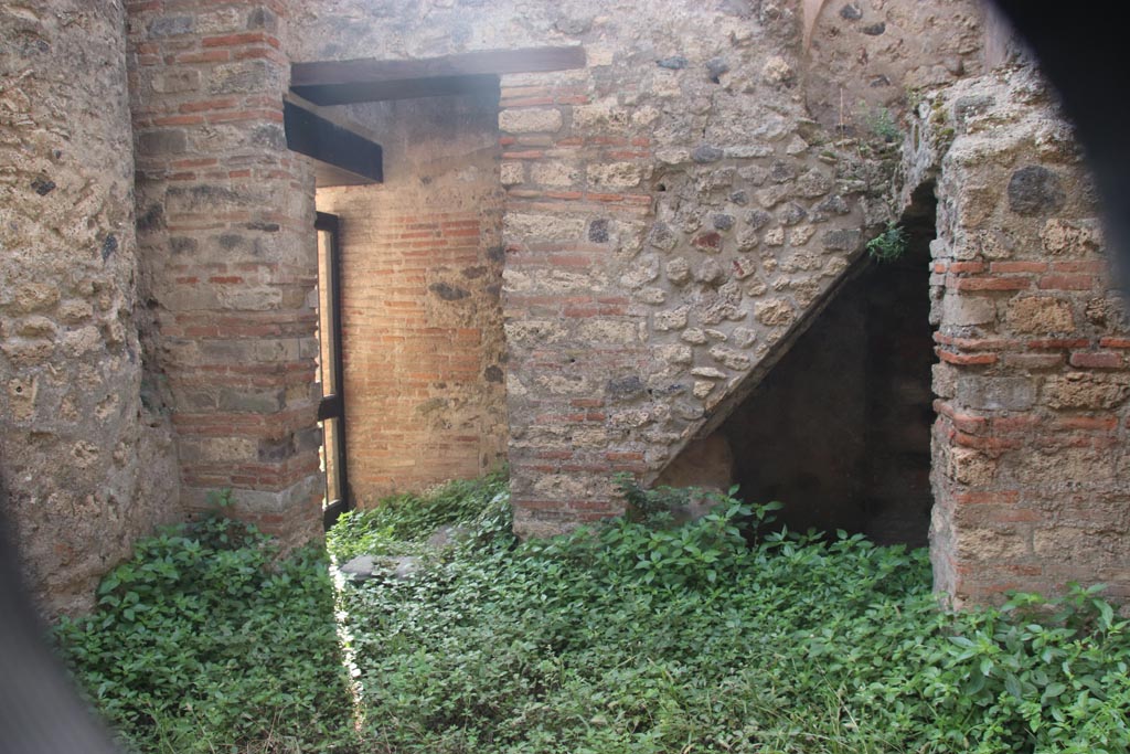 VIII.2.38 Pompeii. October 2023. 
Looking south to doorway to kitchen and steps to upper floor, with recess below. Photo courtesy of Klaus Heese.
