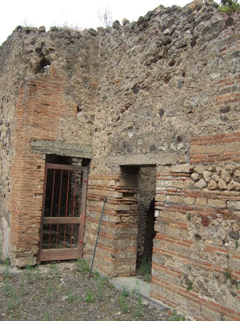 VIII.2.39 Pompeii.  May 2006. Doorways to room n, staircase to upper floor, and kitchen, in north-west corner of atrium. 
