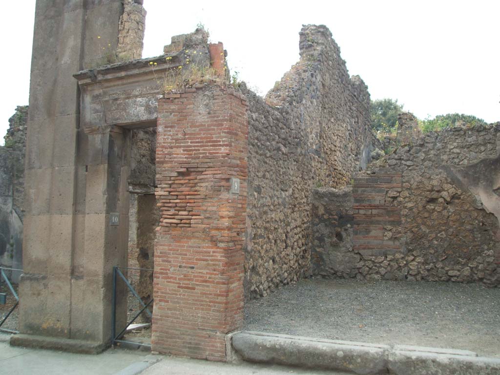 VIII.3.9 Pompeii. May 2005. East wall of shop, with VIII.3.10 on left.
At the top of the brick pilaster on the east wall, that divides VIII.3.10 and 9, can be seen a terracotta down pipe.
