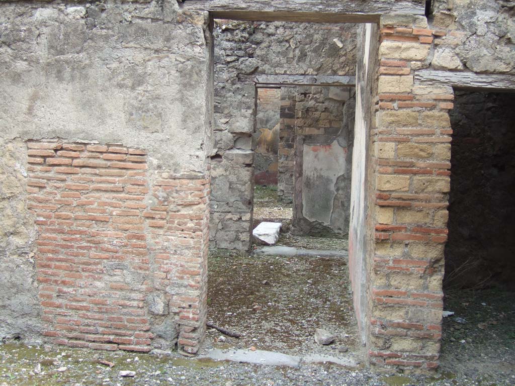 VIII.3.11 Pompeii. May 2006. 
Doorway (centre) in south wall, leading into triclinium with window, and through doorway into courtyard near entrance at VIII.3.12.
