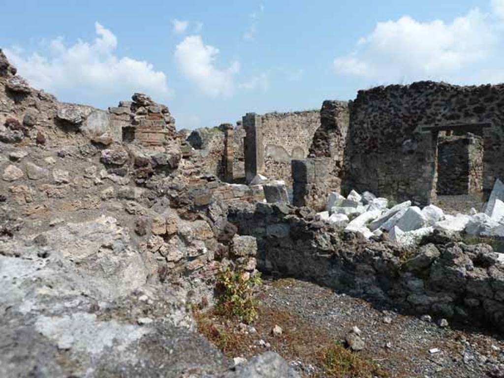 VIII.3.31 Pompeii. May 2010. Looking north-east across small room or cupboard, towards the oecus with two doorways. Taken across the wall of VIII.3.29.
