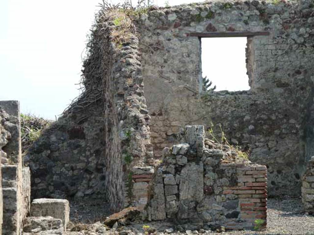 VIII.3.31 Pompeii. May 2010. On the left, the corridor to an exedra, two cubicula, the kitchen and latrine.  According to Fiorelli, found in the exedra reached by the corridor, was a landscape painting showing Hercules and Telamon freeing Hesione. Nothing remains other than the description by Helbig. On the right a large exedra with window. Taken across the wall of VIII.3.29.
See Fiorelli, G., 1875. Descrizione di Pompei, Napoli, (p.331)
See Helbig, W., 1868. Wandgemälde der vom Vesuv verschütteten Städte Campaniens. Leipzig: Breitkopf und Härtel. (H 1131)

