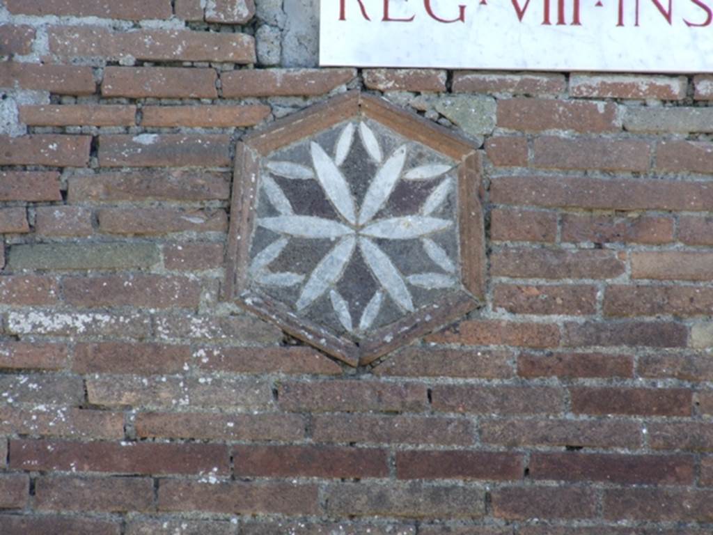 VIII.4.1 Pompeii. March 2009. Plaque with geometric design on outside pillar, on the right of entrance doorway