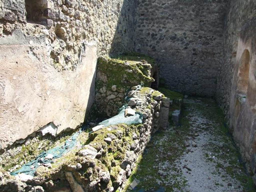 VIII.4.4 Pompeii.  March 2009.  Room 7.   Kitchen.  Looking south.  East wall, with remains of masonry structure.