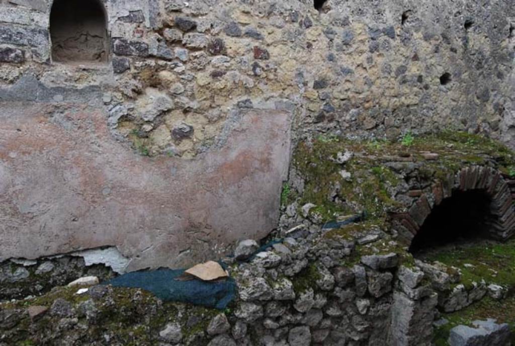 VIII.4.4 Pompeii. April 2009. Looking towards east wall, niche, masonry structure and hearth.  Photo courtesy of Nicolas Monteix.
