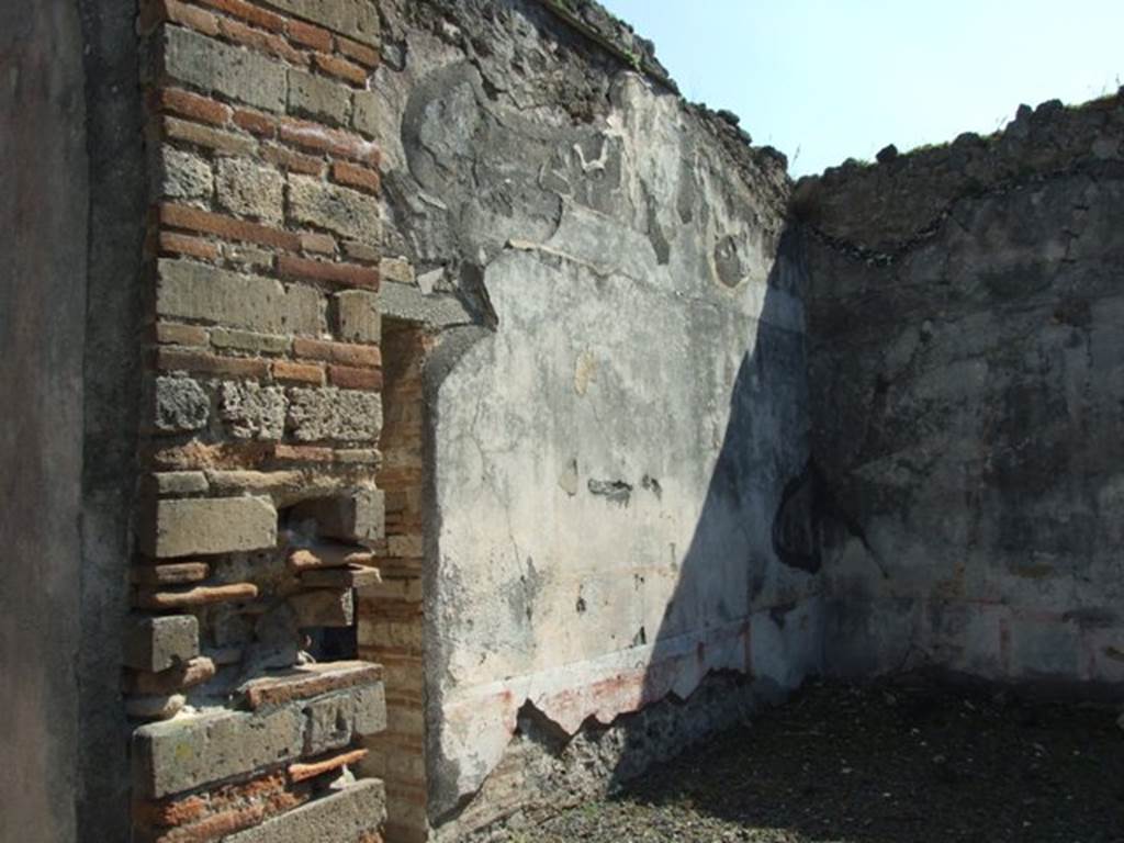 VIII.4.4 Pompeii. March 2009. Room 11. east wall of exedra, and with small doorway to room 10. In the centre would have been the wall painting of Hermaphrodite, now completely lost.
