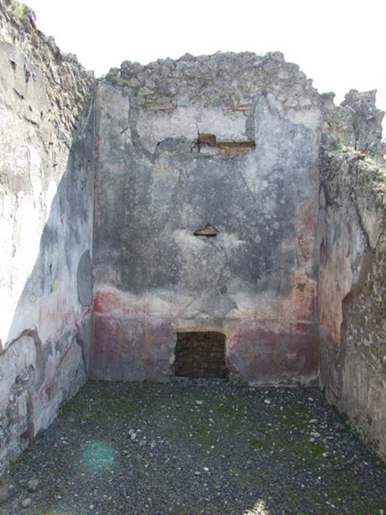 VIII.4.4 Pompeii. March 2009. Room 12, south wall. In the red zoccolo, at the centre was a panel with a border, to the sides were narrow panels with birds and plants. The middle yellow zone contained a painting at the centre showing the contest of the divinity of the light. The side panels were red; the upper zone was faded.
