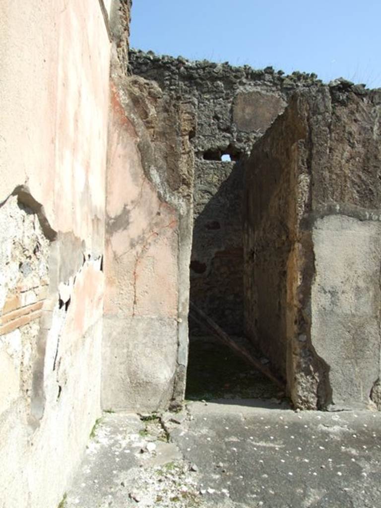 VIII.4.4 Pompeii. March 2009. Doorway to room 2, the rear room of shop at VIII.4.5.
The floor of the atrium shows a simple covering in lavapesta punctuated with a regular white dot tesserae.
