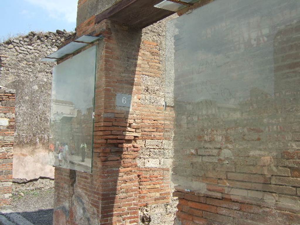 VIII.4.6 Pompeii. May 2006. Remaining black and red painted graffiti on either side of entrance.