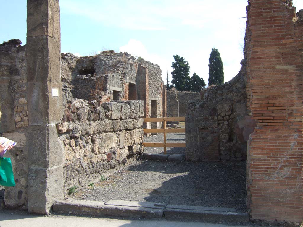 VIII.4.12 Pompeii. May 2005. Looking south across shop to dwelling at rear.