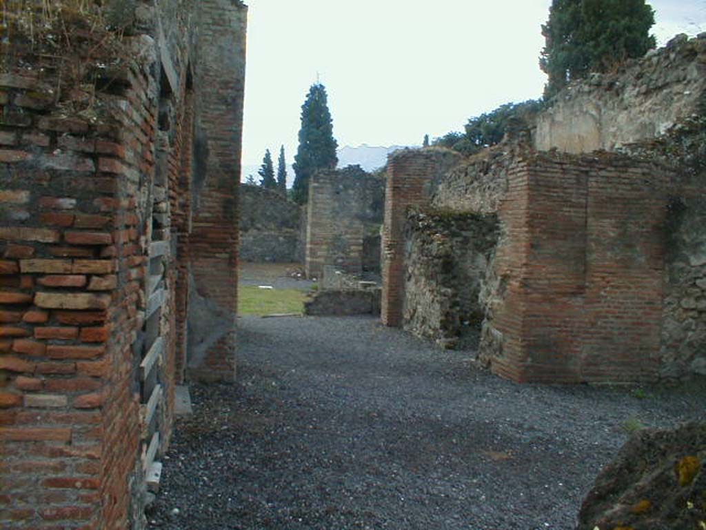 VIII.4.12 Pompeii. September 2005. Entrance, looking south-east.
According to Della Corte, found on the pilaster to the left of the entrance, was the graffito
Tonsores  (rogant)    [CIL IV 743]
See Della Corte, M., 1965.  Case ed Abitanti di Pompei. Napoli: Fausto Fiorentino. (p.237)
According to Epigraphik-Datenbank Clauss/Slaby, the graffito read
A(ulum) Trebium
aed(ilem) tonsores     [CIL IV 743]
(See www.manfredclauss.de)
According to Fiorelli found nearby, were:
(A)  TREBIVM
AED  TONSORES

POPIDIVM  SECUND
               AED
See Pappalardo, U., 2001. La Descrizione di Pompei per Giuseppe Fiorelli (1875). Napoli: Massa Editore. (p.128)

