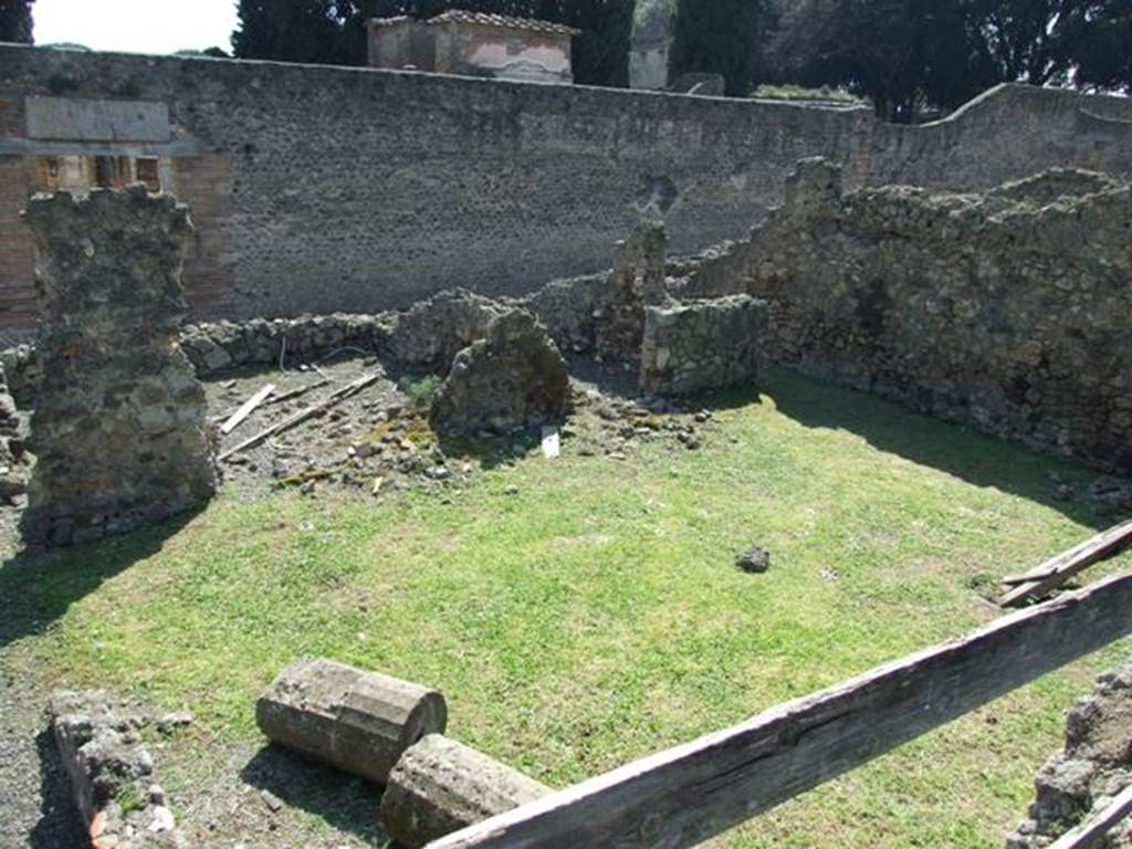 VIII.4.27 Pompeii. March 2009. Looking south from south portico of VIII.4.15, onto lower level. The remains of one of the four columns of VIII.4.15 (?) is lying on the grass, which would have been the peristyle area belonging to VIII.4.27. VIII.4.27s rear entrance at VIII.4.29 is on the south side of peristyle.  According to Boyce, in this peristyle high up on the north wall was an arched niche.
See Boyce G. K., 1937. Corpus of the Lararia of Pompeii. Rome: MAAR 14. (p.76).
According to Jashemski, 
The garden at the rear of the house had a portico on the east supported by two columns. 
There was an arched niche high up on the north wall. A passageway at the south-west corner at the rear of the garden led to the street, directly across from the Temple of Isis.
See Jashemski, W. F., 1993. The Gardens of Pompeii, Volume II: Appendices. New York: Caratzas. (p.214).

 


