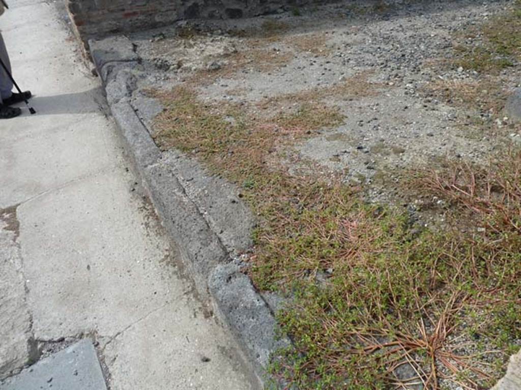 VIII.4.35 Pompeii, September 2015. Threshold of shop doorway, looking towards south-west corner of shop-room.