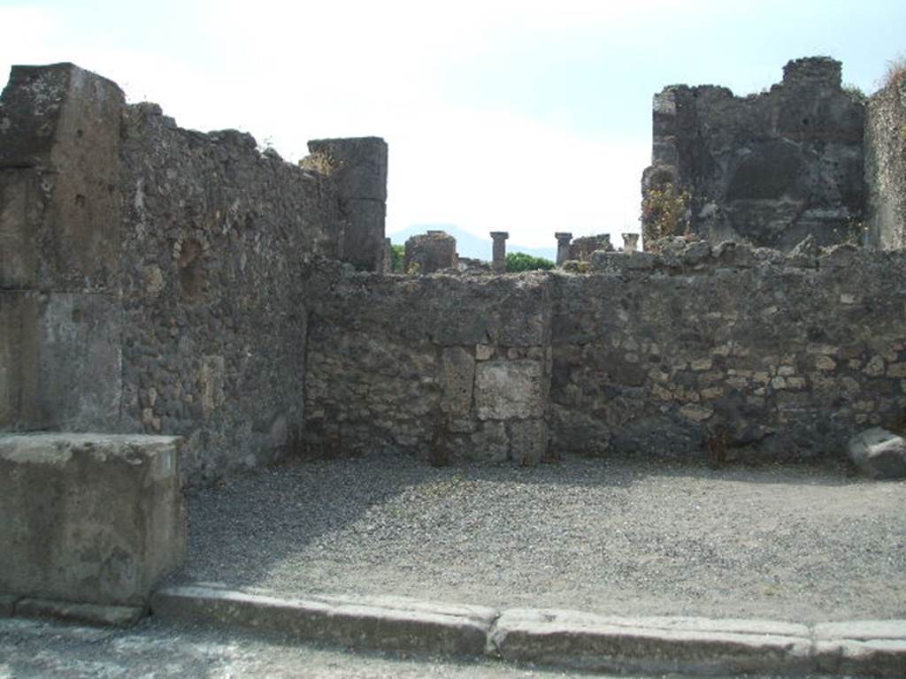 VIII.5.1 Pompeii. May 2005. East side of shop, with niche in east wall.
According to Boyce, the arched niche was called by Fiorelli la nicchia dei Penati.
See Boyce G. K., 1937. Corpus of the Lararia of Pompeii. Rome: MAAR 14. (p.76, no.364) 
See Pappalardo, U., 2001. La Descrizione di Pompei per Giuseppe Fiorelli (1875). Napoli: Massa Editore. (p.163).
According to Fiorelli, this shop originally had a doorway at the rear, that would have linked it with the atrium of VIII.5.2, but then was blocked up.
See Fiorelli, G. (1875). Descrizione di Pompei, (p.446).
