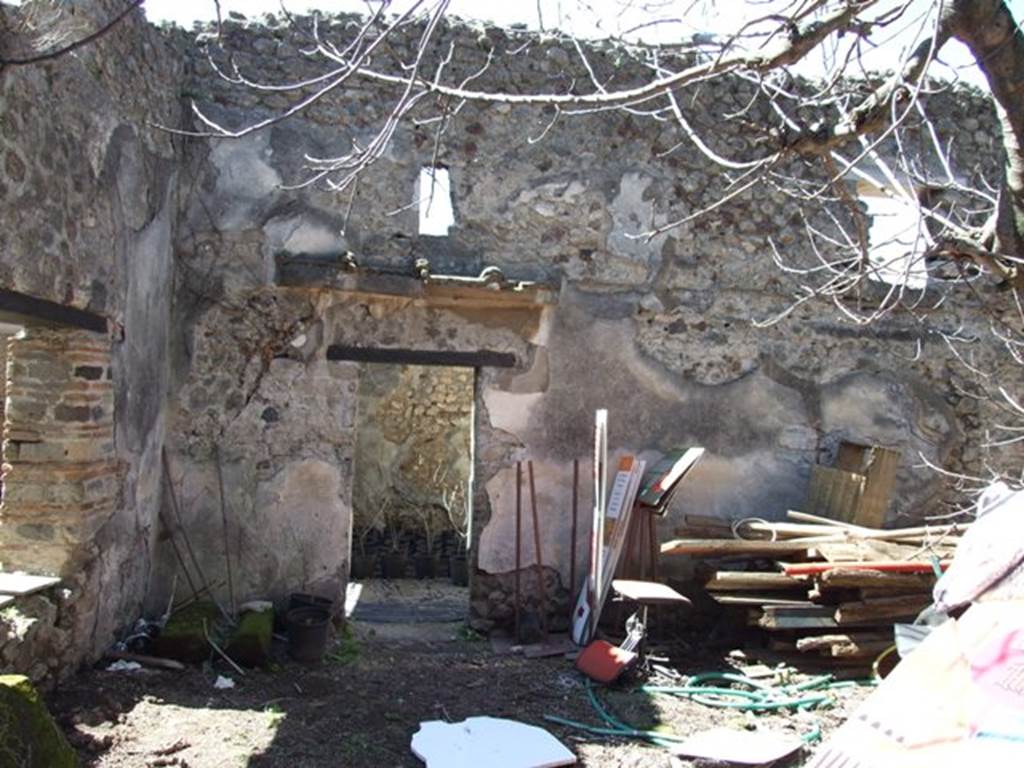 VIII.5.16 Pompeii. March 2009. 
Room 11, small garden area, looking west to south-west corner, and west wall with doorway into room 9.
