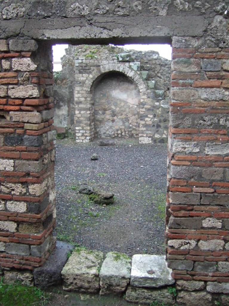 VIII.5.17 Pompeii. December 2005. Rear entrance doorway. According to Jashemski, the garden at the rear of the caupona was entered at number 17. On the rear wall of the garden was a crudely painted picture of Silenus stretched out among plants. See Jashemski, W. F., 1993. The Gardens of Pompeii, Volume II: Appendices. New York: Caratzas. (p.216 and Fig 251 for painting of Silenus)
