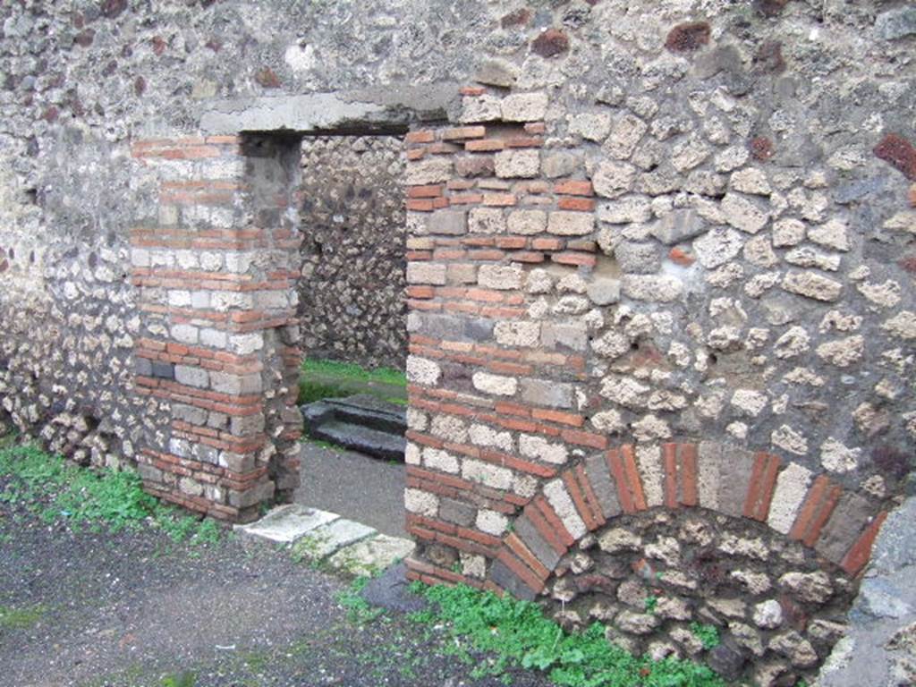 VIII.5.17 Pompeii. December 2005. West wall with doorway, looking into small vicolo.

