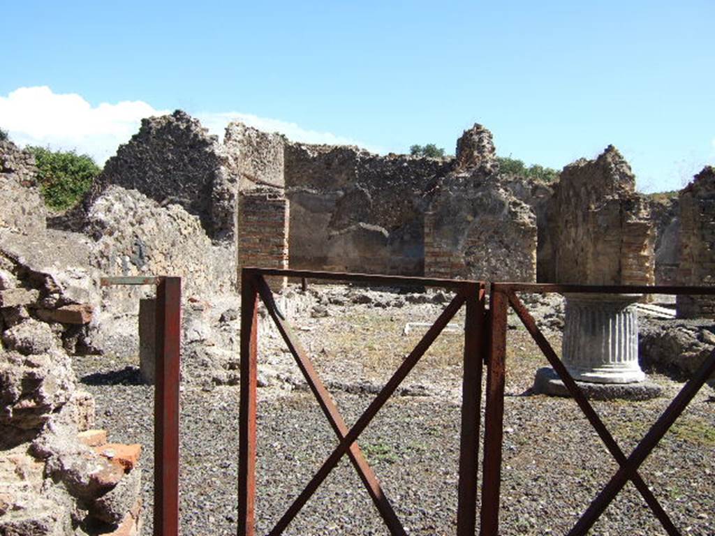 VIII.6.10 Pompeii. September 2005. Looking east from entrance into area of peristyle.
According to Mau, upon entering the doorway, found on the right on the entrance wall was a “boss” in the guise of a pillar. It was 1.40m wide, 0.30 deep, and 1.15m high.
It conserved remains of a coating of marble, and on the wall above were the remains of a lararium painting: it was clear, therefore, that this boss served as an altar for offerings to the domestic gods. However, it seemed in the last times it was destroyed, and that a cylindrical tufa altar (0.32 high, 0.28 diameter) was used instead, this was still lying in the same corner. See BdI, 1884, p.183
(Appena entrati troviamo a destra al muro d'ingresso una sporgenza a guisa di pilastro: è larga m. 1,40, profonda 0,30, ed era alta 1,15. Conserva avanzi d'un rivestimento di marmo, e sulla parete sovrastante sonvi quelli della pittura lararia: è chiaro dunque che questa sporgenza serviva da altare per le offerte ai Lari. Pare però che negli ultimi tempi fosse distrutta e che invece si servissero d'un'aretta cilindrica di tufo (a. 0,32, diam. 0,28) che tuttora si trova nell'angolo stesso).

According to Boyce, there was a projecting base against the wall to the right of the entrance from the street, into the peristyle. (not photographed yet). Traces of the original covering with slabs of marble could be seen. Above it were the remains of the vanished lararium painting. The top of the pilaster may have served as an altar for offerings. Found nearby was a small cylindrical altar of tufa. Mau thought this may have been used instead of the pilaster top, during the last days of the city. Boyce’s reference - Bull.Inst, 1884, 183.
See Boyce G. K., 1937. Corpus of the Lararia of Pompeii. Rome: MAAR 14. (p.78, no.375) 
