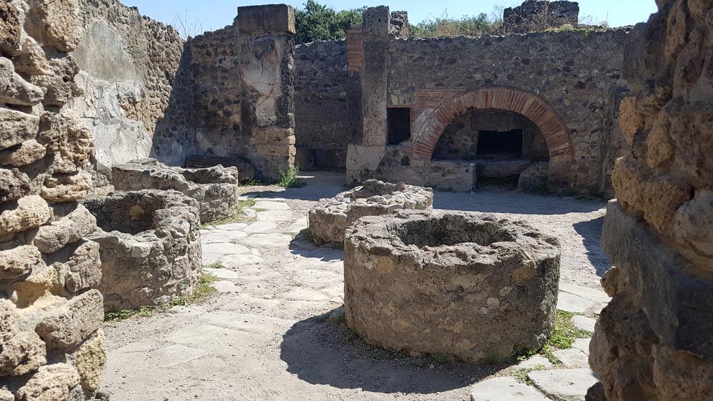 VIII.6.11 Pompeii. August 2023. Looking east towards oven across bakery room. Photo courtesy of Maribel Velasco.