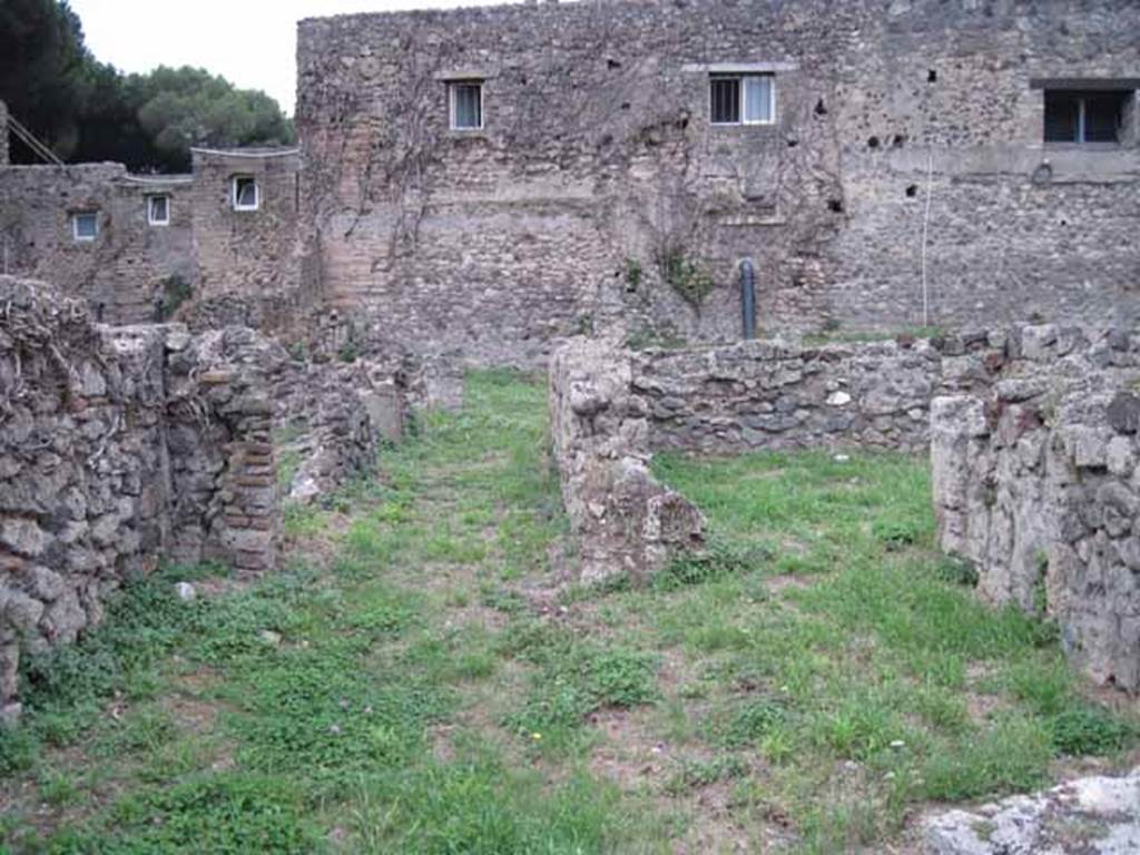 VIII.7.11 Pompeii. September 2010. Looking west across rear room to corridor and doorway to cubiculum (on right). Photo courtesy of Drew Baker.
