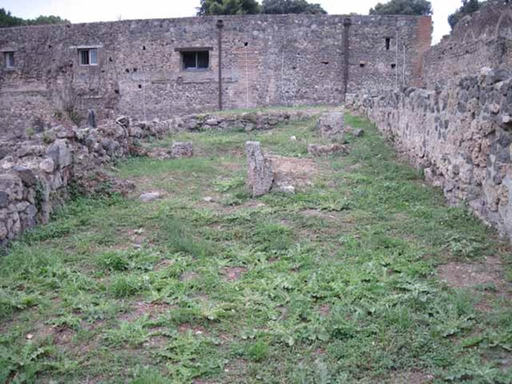 VIII.7.14 Pompeii. September 2010. Looking west across shop, to small rear room on left, and site of corridor with steps to upper floor and kitchen area, on right. Photo courtesy of Drew Baker.
