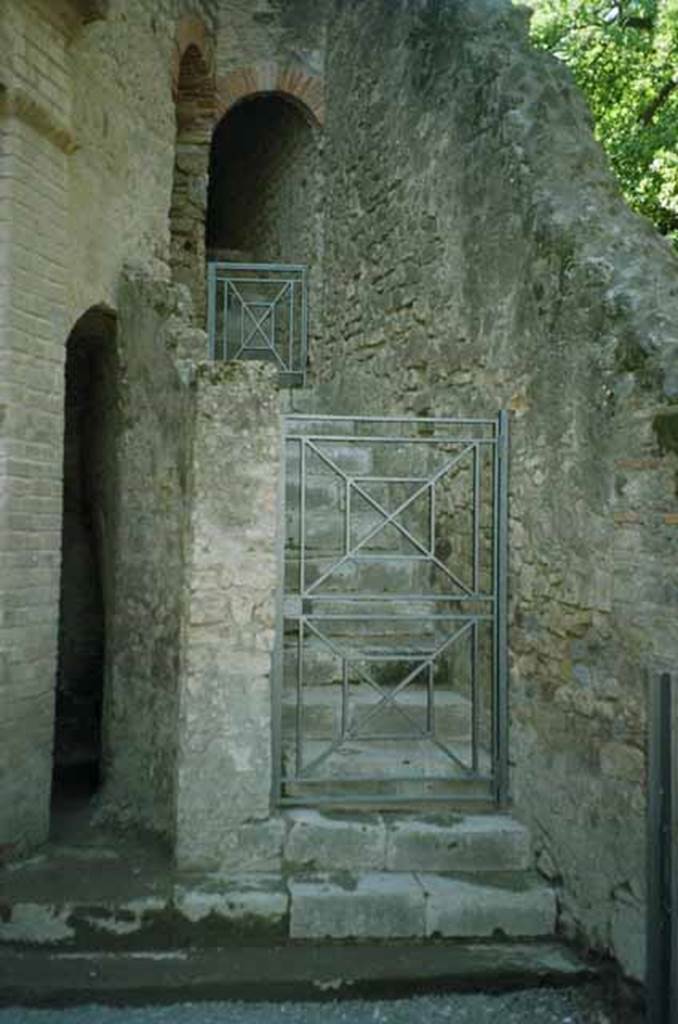 VIII.7.21 Pompeii. Restored steps to upper level. July 2010. The tall narrow arch to the left leads to the Theatre latrine. Photo courtesy of Rick Bauer.