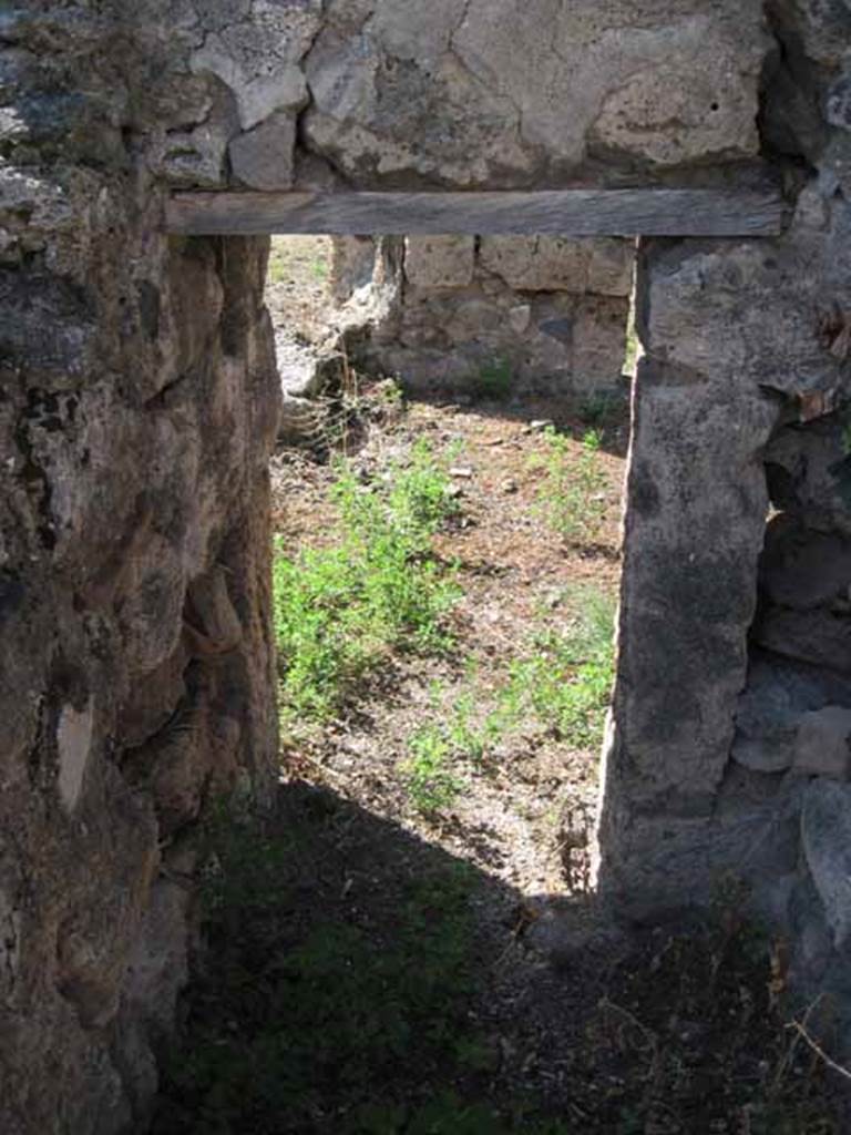 VIII.7.26 Pompeii. September 2010. Looking west from small storeroom or cupboard through doorway into triclinium. Photo courtesy of Drew Baker.
