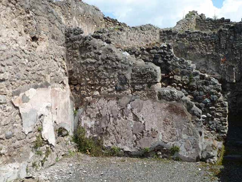 IX.1.1 Pompeii. May 2010.  East wall of shop, with site of latrine behind it.