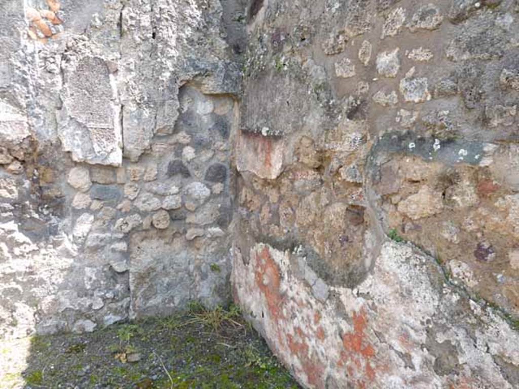 IX.1.1 Pompeii. May 2010.  South-east corner of rear room, with remains of painted red zoccolo/plinth.