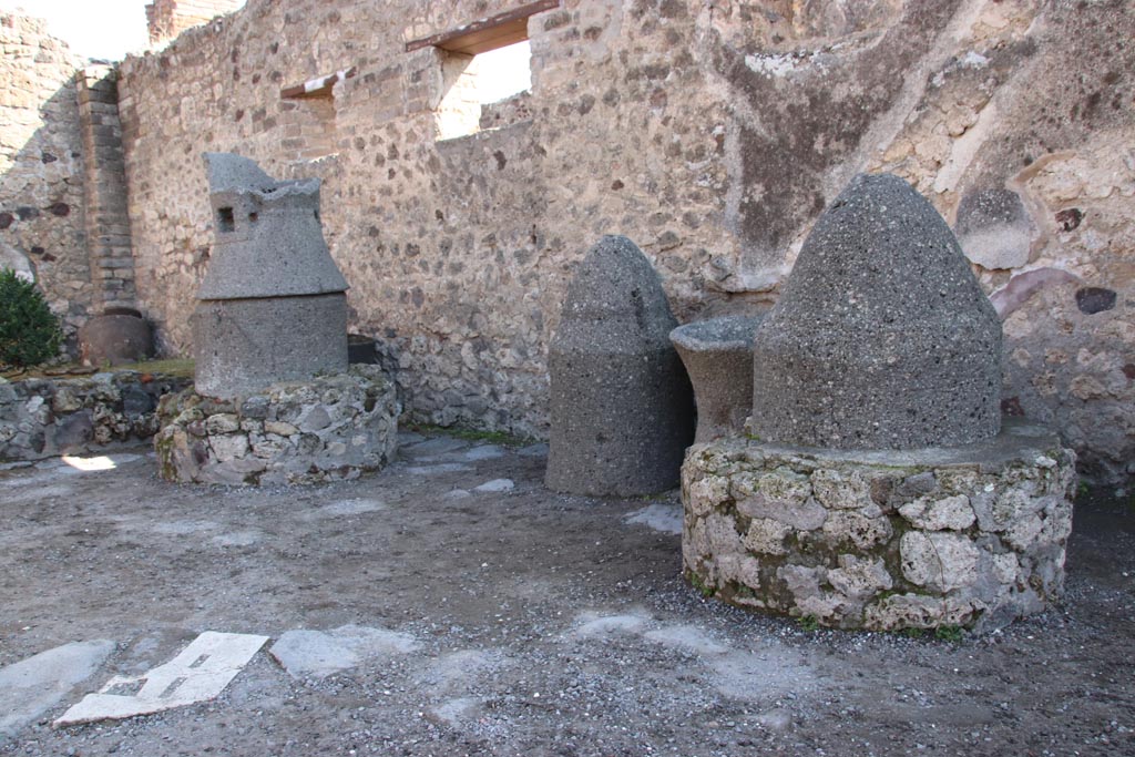 IX.1.3 Pompeii. October 2022. Mills against the south wall, at the rear of the bakery shop. Photo courtesy of Klaus Heese