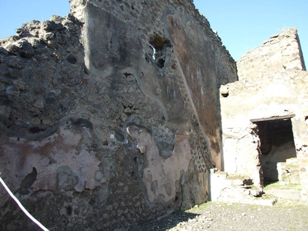 IX.1.4 Pompeii.  March 2009.  Stone steps in north-east corner of shop with outline of stairs in remains of high zoccolo/plinth of cocciopesto on north wall.

