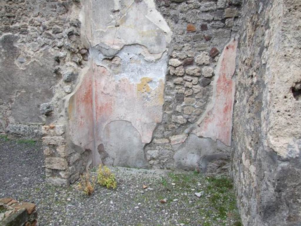 IX.1.7 Pompeii. December 2007. Narrow tablinum, in centre of east end of atrium with corridor behind. On the east wall of this room the zoccolo was discoloured, in the middle zone was a yellow central panel, with two red side panels. According to Fiorelli, this was a narrow tablinum, adorned with the painting of a dove with its beak in a jewel coffer, near to which was another necklace, but now lost.

