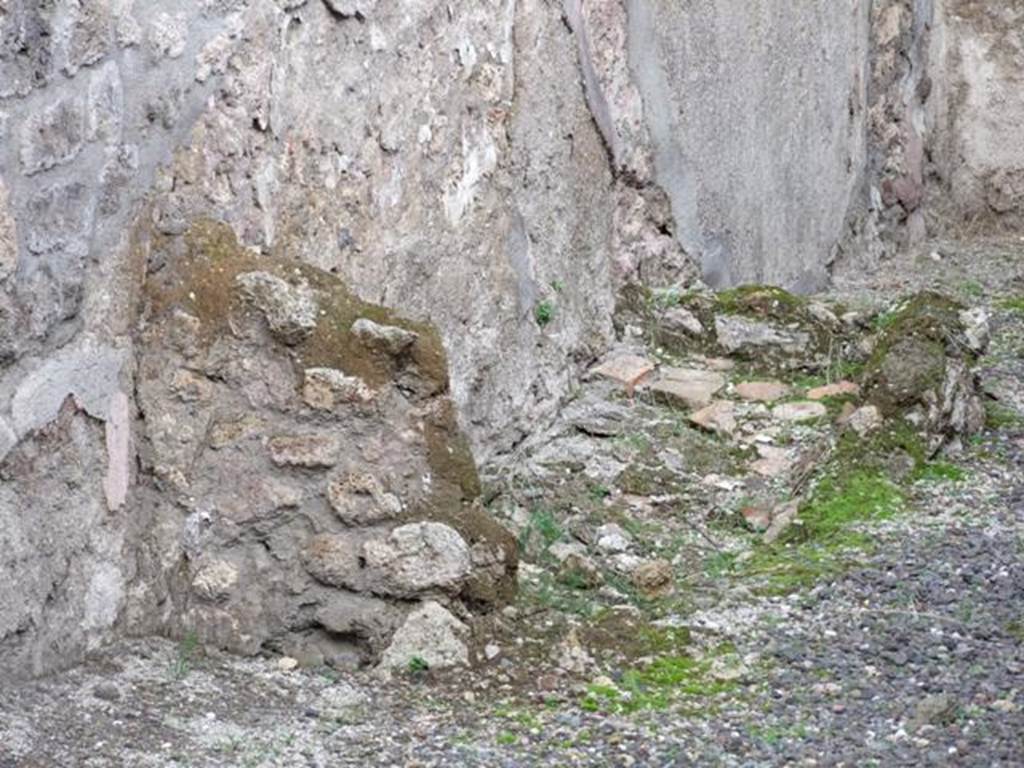 IX.1.8 Pompeii. December 2007.  Remains of base of steps to upper floor against the north wall in rear room.

