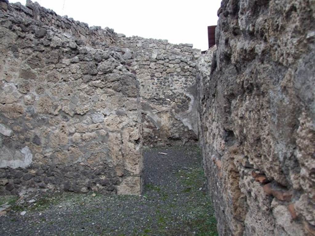 IX.1.9 Pompeii. December 2007. East wall of shop, with doorway to rear room.