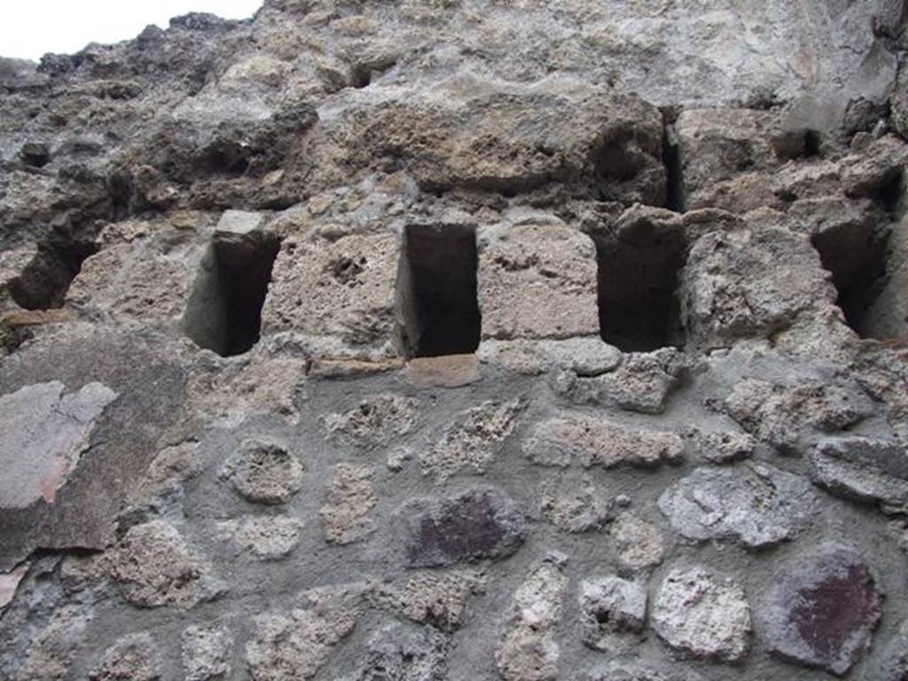 IX.1.12 Pompeii. December 2007. 
South wall of room with open doorway in centre of south wall of atrium showing holes for upper floor supports.

