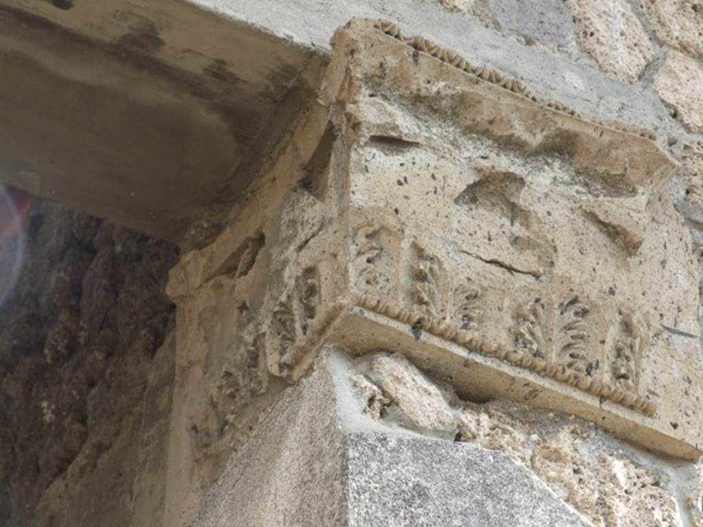 IX.1.20 Pompeii.  December 2007.  Room 2.  Atrium.  East Side.   Figured capital from south eastern corner consisting of a bust above a band of acanthus (damaged).
