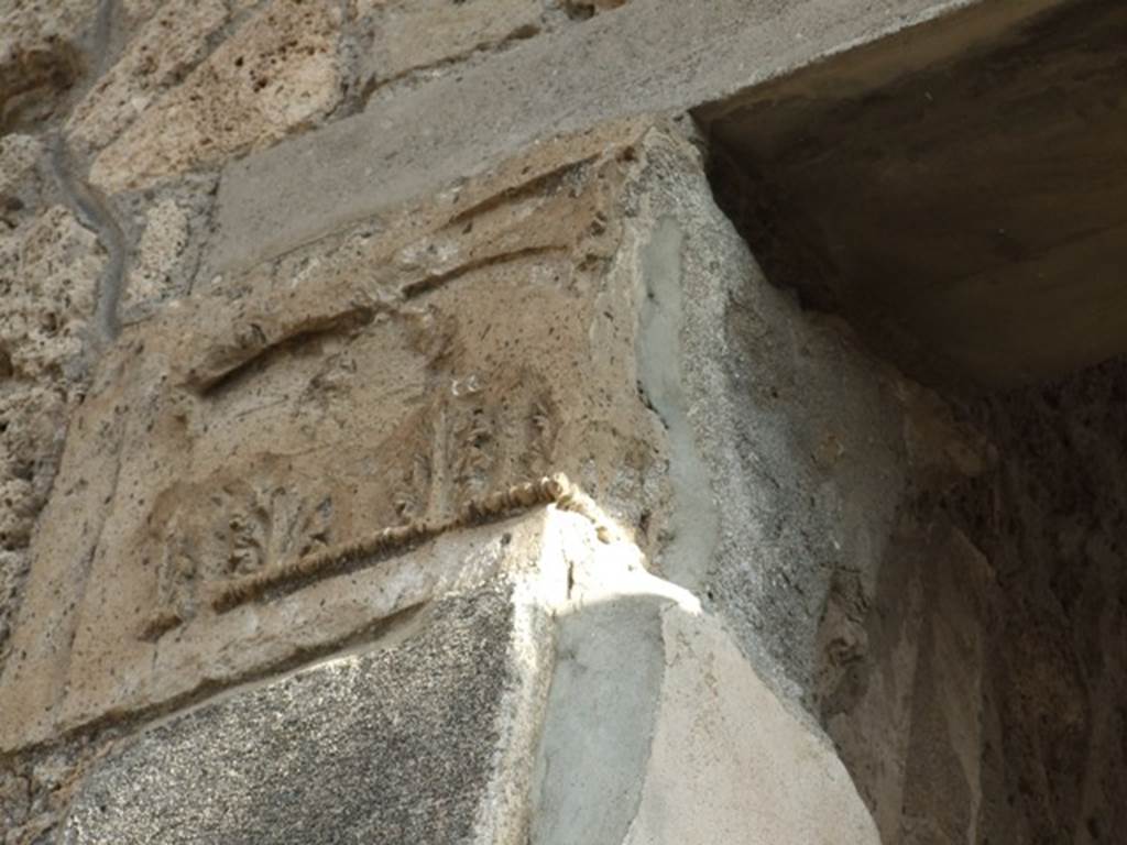 IX.1.20 Pompeii.  December 2007.  Room 2.  Atrium.  East Side. Figured capital from north eastern corner consisting of a bust above a band of acanthus (damaged).
