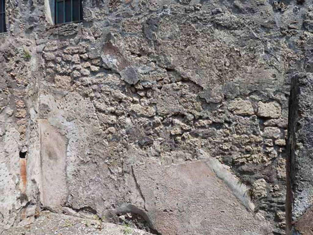 IX.1.24 Pompeii. May 2010. North-east corner with downpipe, and east wall.