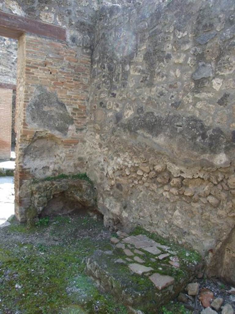 IX.1.27 Pompeii. March 2009.  South-west corner at front of shop, with remains of hearth. On the left of the entrance, was the hearth and an altar. According to Boyce, it was a kind of altar with a small niche in the wall above it  presumably for the cult of the Lares. Apparently fixed to it there was a marble slab bearing the inscription
PACVVIVS . ERASISTRATVS . EX . VIsv   [CIL X 930]
Boyce also noted that Fiorelli said nothing about the connection between the altar and the incised slab but noted that the slab had been re-used as materiale di costruzione.
See Boyce G. K., 1937. Corpus of the Lararia of Pompeii. Rome: MAAR 14. (p.80) 
See Pappalardo, U., 2001. La Descrizione di Pompei per Giuseppe Fiorelli (1875). Napoli: Massa Editore. (p.140)
Cooley translates the latin inscription to
Pacuvius Erasistratus, after a vision.    [CIL X 930]
See Cooley, A. and M.G.L., 2004. Pompeii : A Sourcebook. London : Routledge. (p.106, E58), where it is said to have come from IX.1.25.
According to Boyce above, the place of discovery of CIL X 930, was given as IX.1.25, but wrongly so; cf. Fiorelli and the Bull.Inst.
He gives the references - Fiorelli, Descr., 376; Bull. Inst., 1867, 162.
