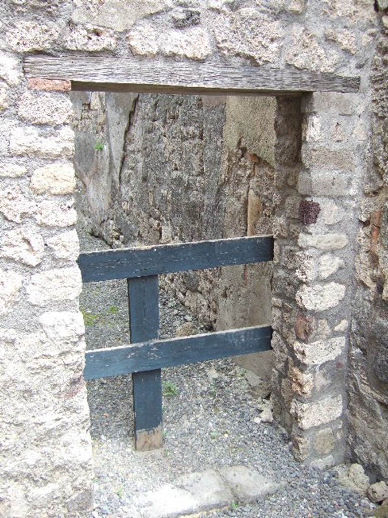 IX.2.8 Pompeii. May 2006. Doorway in east wall, leading to rear. On the south wall can be seen a terracotta downpipe.