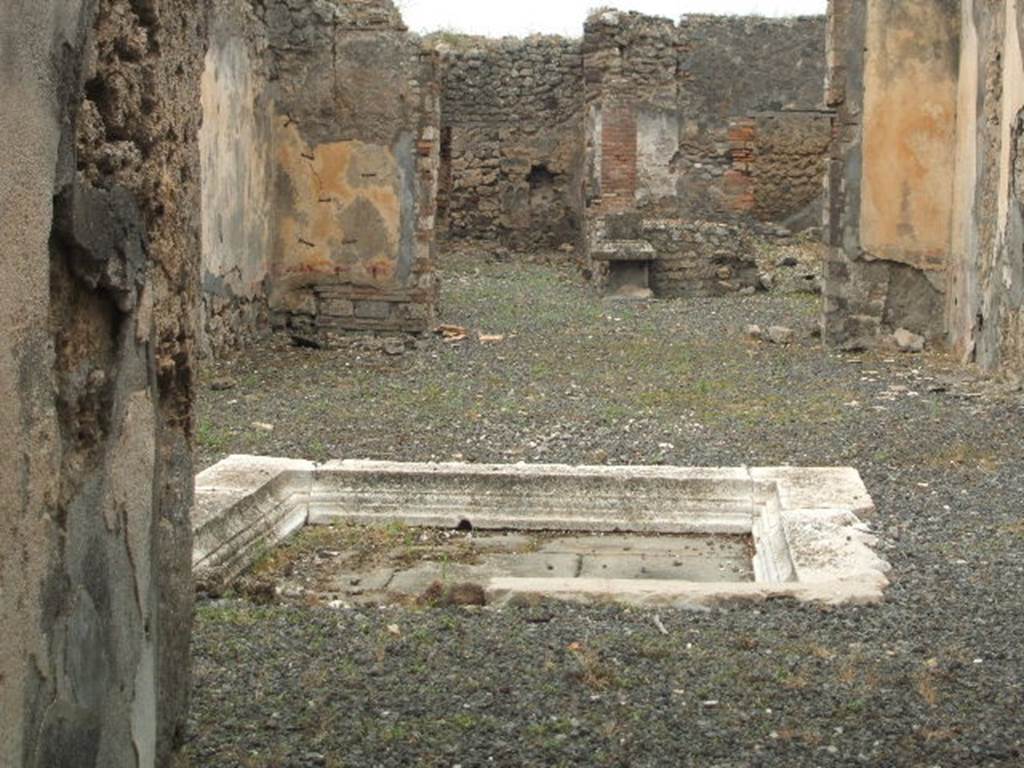 IX.2.18 Pompeii. May 2005. Impluvium in atrium. Looking west across atrium and through tablinum to the garden area.