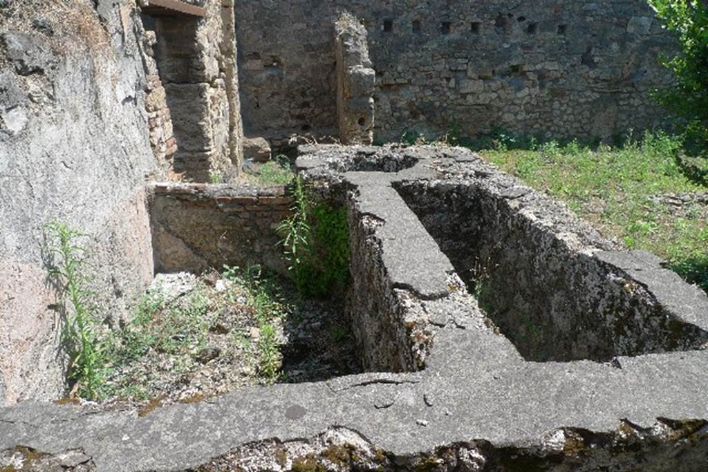 IX.2.24 Pompeii. July 2010. Looking east across watering trough, cistern and reservoir on north side of yard. Photo courtesy of Michael Binns.