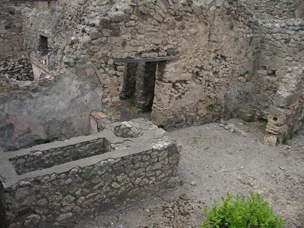 IX.2.24 Pompeii. May 2003. Looking north-east from top of stairs towards podium  and latrine. Photo courtesy of Nicolas Monteix.
